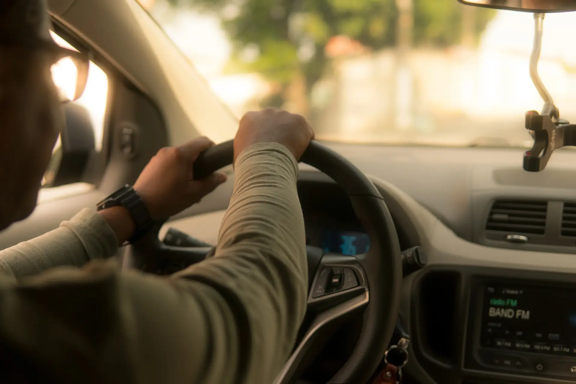 customer happy driving with our auto insurance booklet in his dashboard